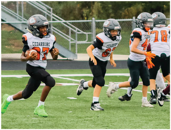 A group of football players on a field. Description generated by AI