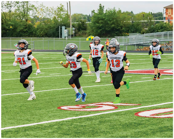 A group of football players on a field. Description generated by AI