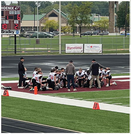 A group of football players celebrating a touchdown. Description generated by AI