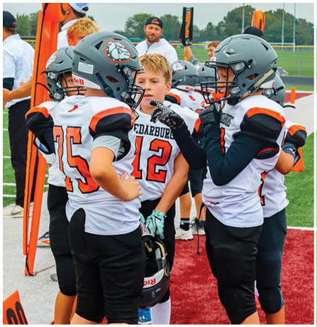 A group of football players celebrating a touchdown. Description generated by AI