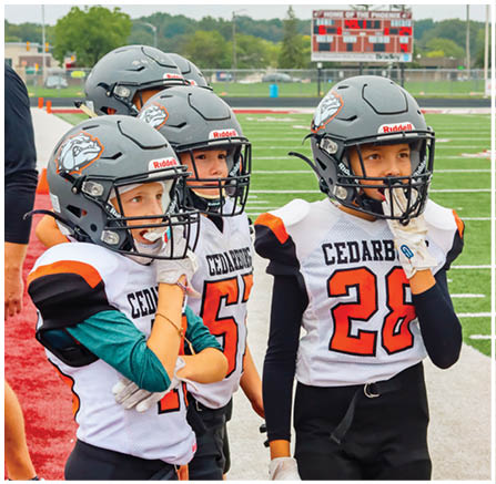 A group of football players celebrating a touchdown. Description generated by AI
