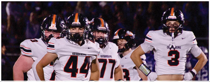 A group of football players on a field. Description generated by AI