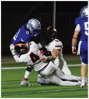 A group of football players celebrating a touchdown. Description generated by AI