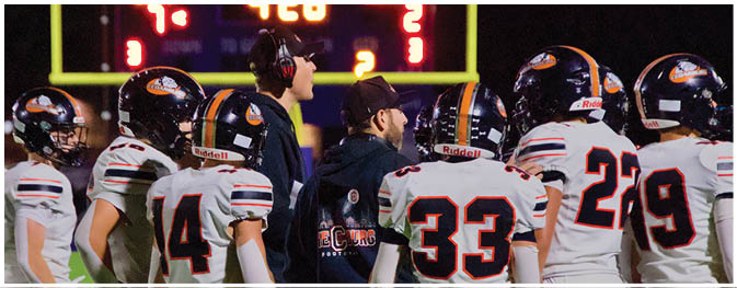 A group of football players on a field. Description generated by AI
