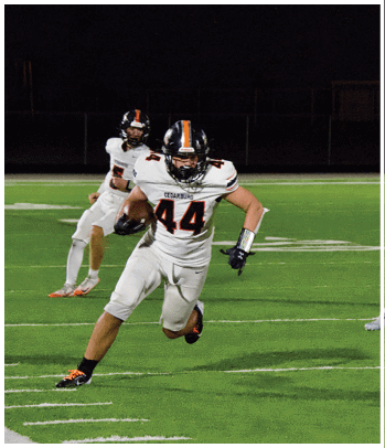A group of football players celebrating a touchdown. Description generated by AI