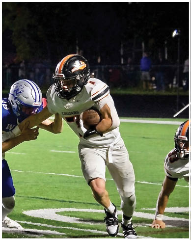 A football player wearing a blue and red jersey. Description generated by AI
