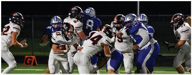 A group of football players on a field. Description generated by AI