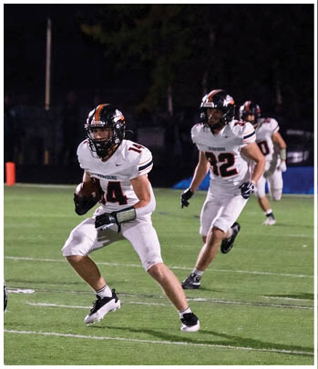 A group of football players celebrating a touchdown. Description generated by AI