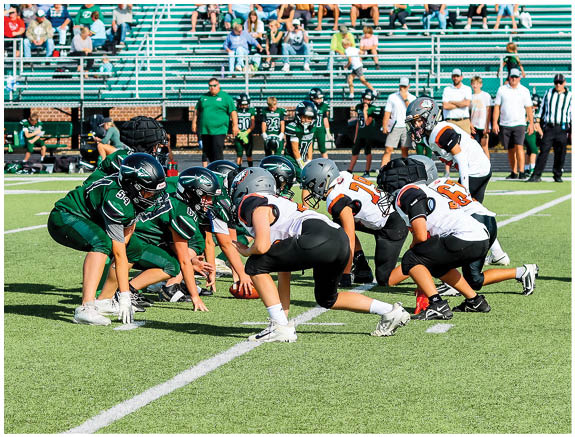 A group of football players on a field. Description generated by AI