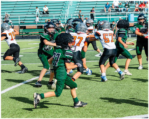 A group of football players on a field. Description generated by AI