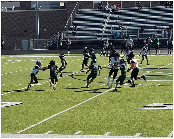 A group of football players on a field. Description generated by AI