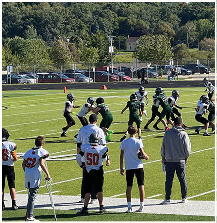 A group of football players celebrating a touchdown. Description generated by AI