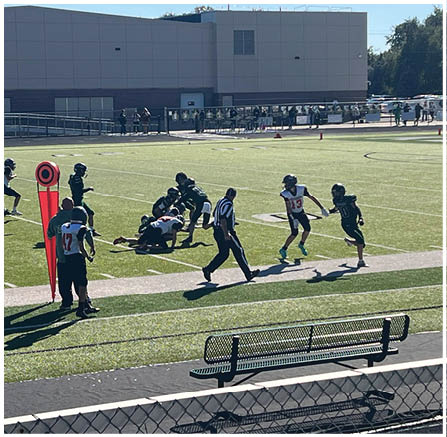 A group of football players celebrating a touchdown. Description generated by AI