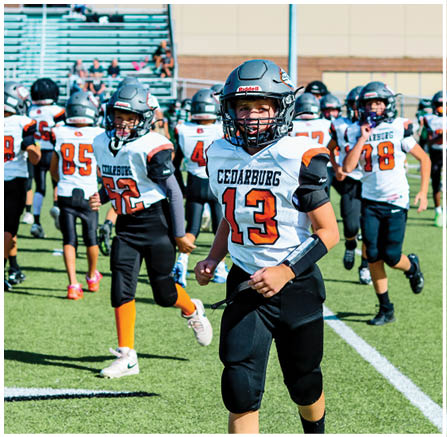 A group of football players celebrating a touchdown. Description generated by AI