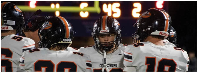 A football game is taking place on a field with players wearing blue and white uniforms. Description generated by AI