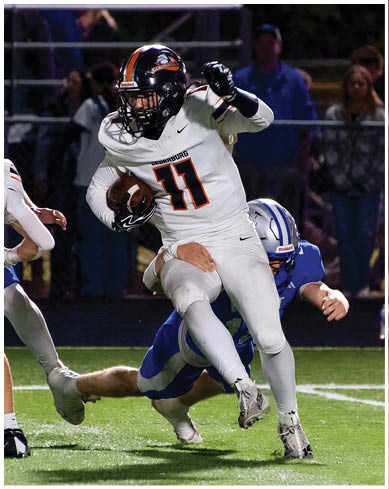 A football player wearing a blue and red jersey. Description generated by AI
