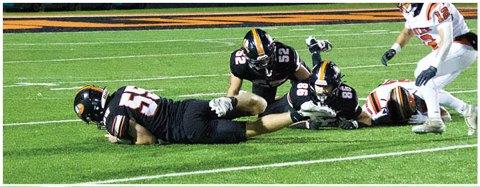 A group of football players on a field. Description generated by AI
