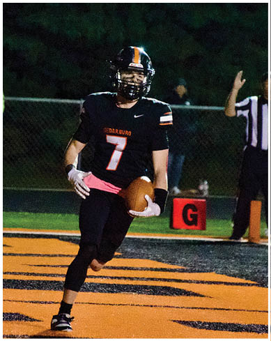 A football player wearing a blue and red jersey. Description generated by AI