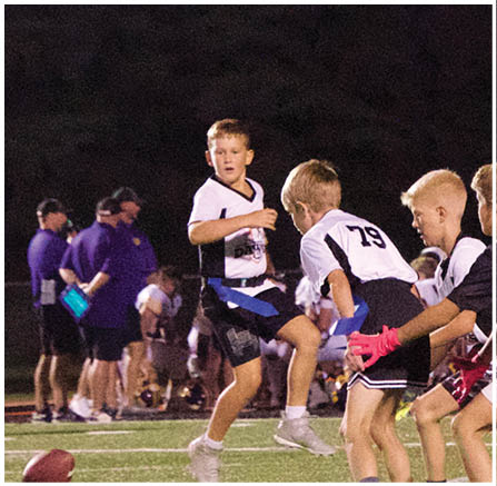 A group of football players celebrating a touchdown. Description generated by AI
