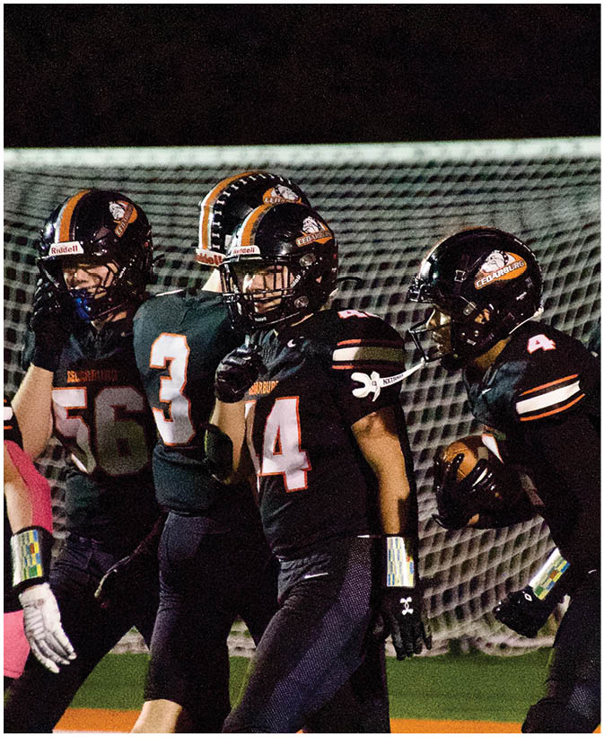 A group of football players on a field. Description generated by AI