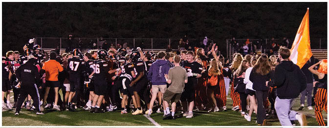 A group of football players on a field. Description generated by AI