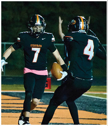 A group of football players celebrating a touchdown. Description generated by AI