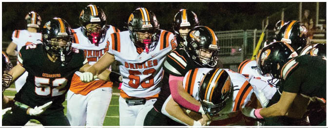 A group of football players on a field. Description generated by AI