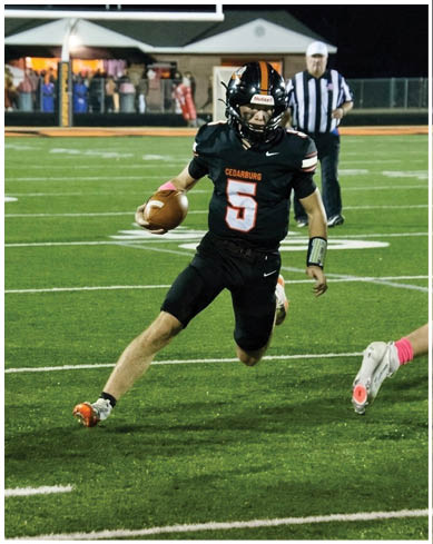 A football player wearing a blue and red jersey. Description generated by AI