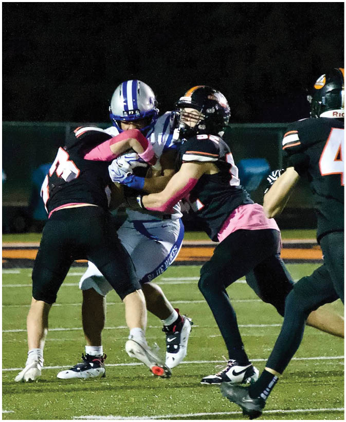 A group of football players on a field. Description generated by AI