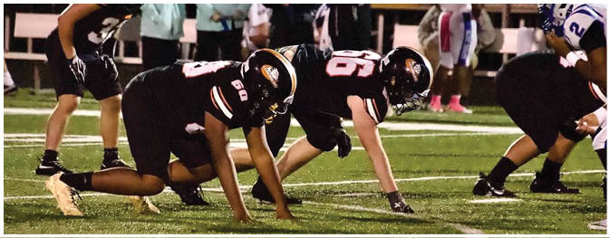 A group of football players on a field. Description generated by AI