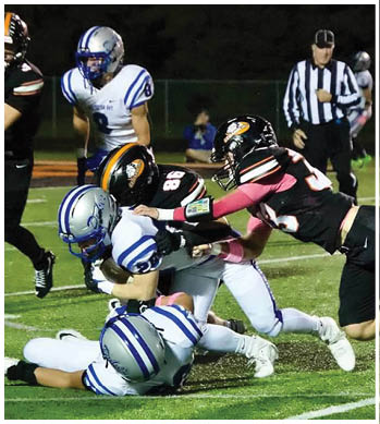 A group of football players celebrating a touchdown. Description generated by AI