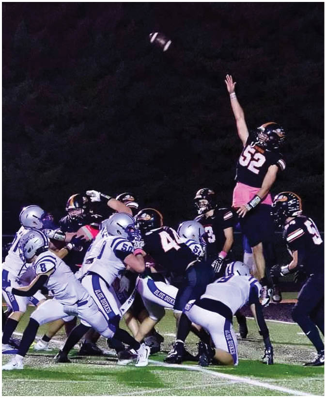 A group of football players on a field. Description generated by AI