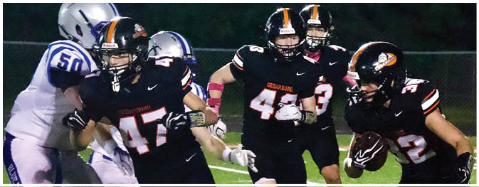 A group of football players on a field. Description generated by AI