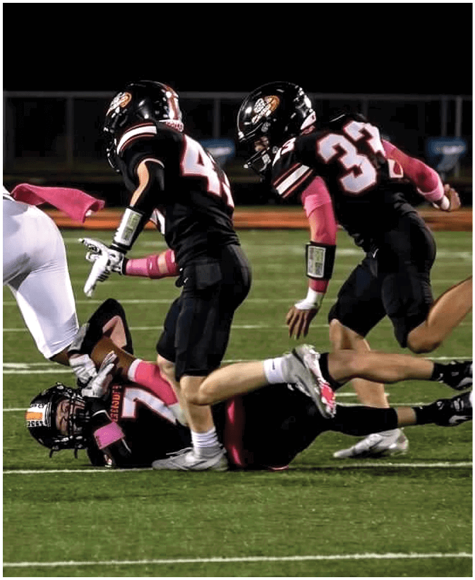 A group of football players on a field. Description generated by AI