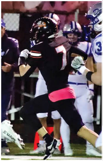 A group of football players celebrating a touchdown. Description generated by AI