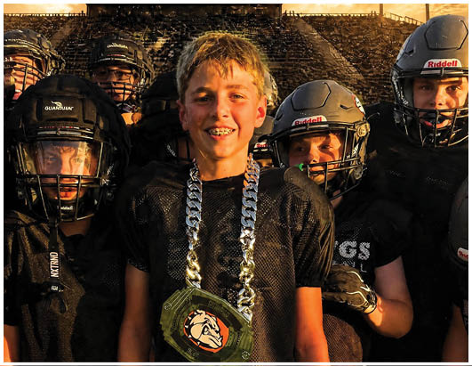 A group of football players on a field. Description generated by AI