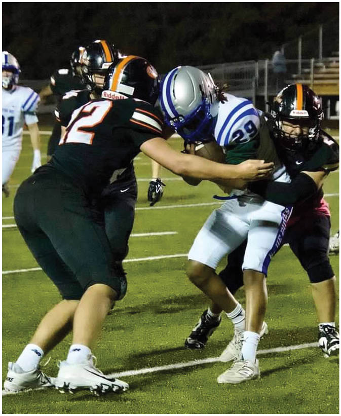 A group of football players on a field. Description generated by AI