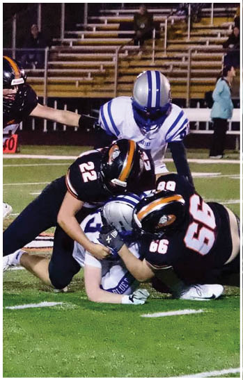 A group of football players celebrating a touchdown. Description generated by AI