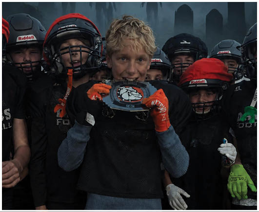 A group of football players on a field. Description generated by AI