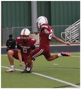 A group of football players on a field. Description generated by AI