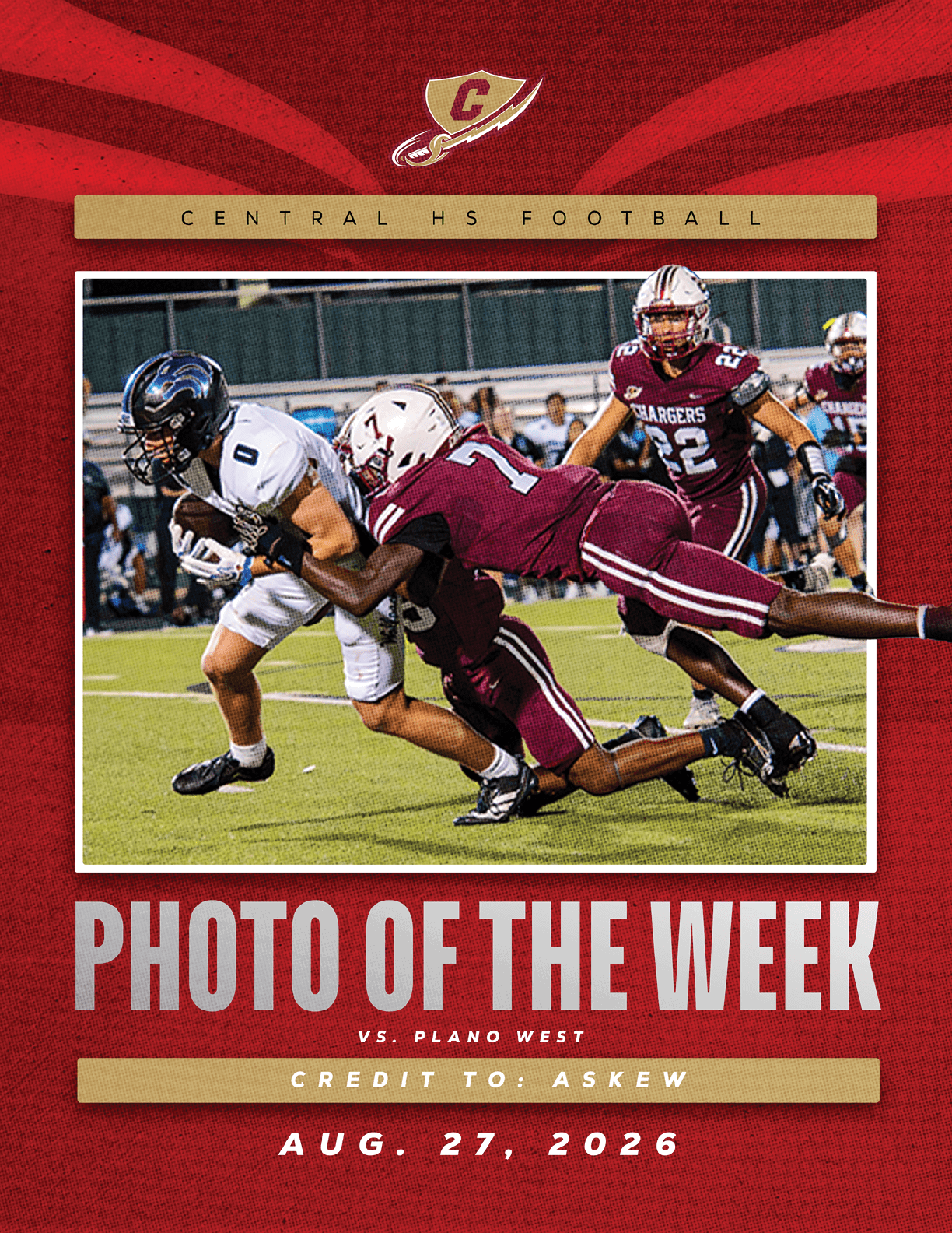 A football player in a white uniform is being tackled by a player in a maroon uniform during a game on a green field with other players and spectators in the background. Description generated by AI