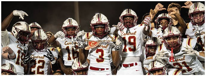 A group of people wearing football uniforms with “Central" on the jerseys are celebrating with raised fists and energetic poses. Description generated by AI