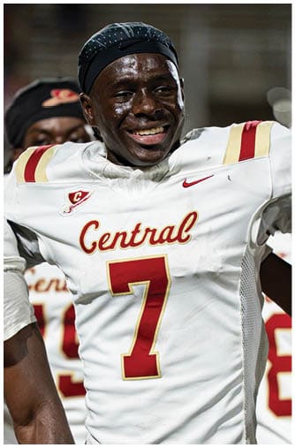 A person wearing a sports headband and uniform is smiling and appears to be celebrating or enjoying a moment during a sporting event. Description generated by AI