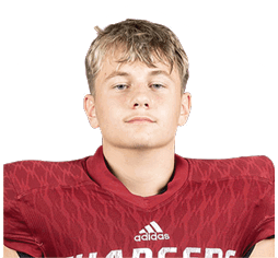 A person wearing a red Adidas football jersey with the word Chargers on the front is looking straight ahead. Description generated by AI