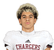 A person with short, curly hair wearing a white football jersey with the word “CHARGERS" and the number 6 on the front. Description generated by AI