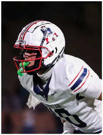 A football player running on the field. Description generated by AI