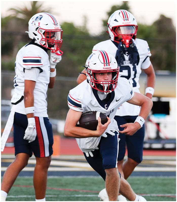 A group of football players wearing black and white uniforms. Description generated by AI