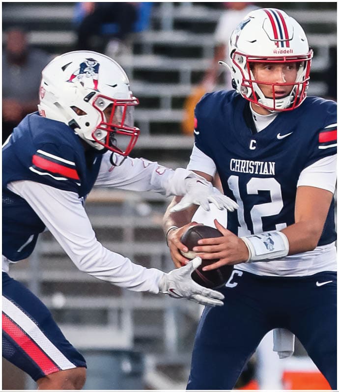 A group of football players wearing black and white uniforms. Description generated by AI