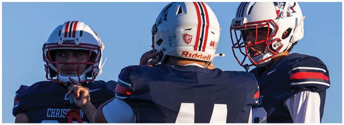 A football player is sliding on the ground. Description generated by AI