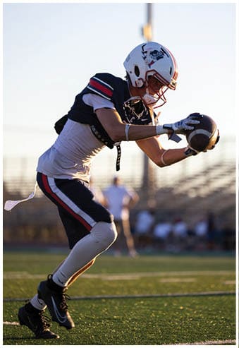 A football player running on the field. Description generated by AI